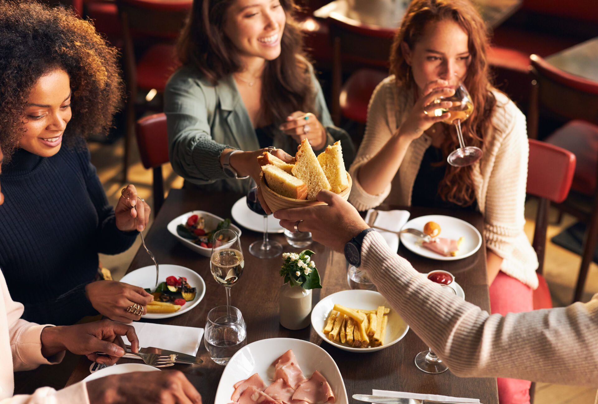 Friends enjoying food and drink in restaurant